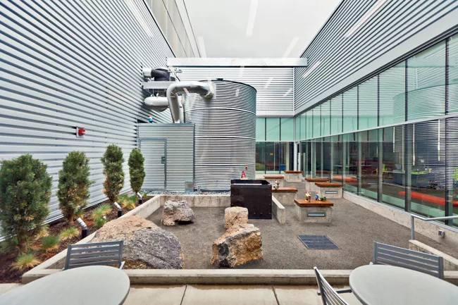 Where courtyards open into the office areas of the building, the concrete wall is replaced with full-height glazing, layered from the entry court deep into the office and the interior courtyard.