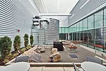 Where courtyards open into the office areas of the building, the concrete wall is replaced with full-height glazing, layered from the entry court deep into the office and the interior courtyard.