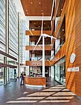 In the airy entrance atrium, a single wind turbine announces the building's dedication to clean, renewable energy.