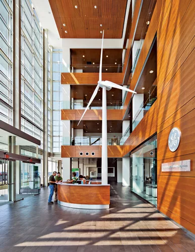 In the airy entrance atrium, a single wind turbine announces the building's dedication to clean, renewable energy.