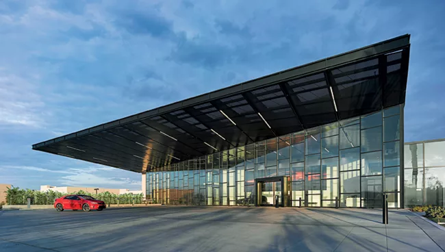 A perforated steel-mesh canopy cantilevers out over the dramatic lobby (top), providing shade while admitting light to penetrate through it.