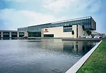 The 36,000-square-foot reflecting pond can be seen from all three floors of the main building. A glass bridge connects two tilt-up concrete bar buildings and contains administrative and executive offi