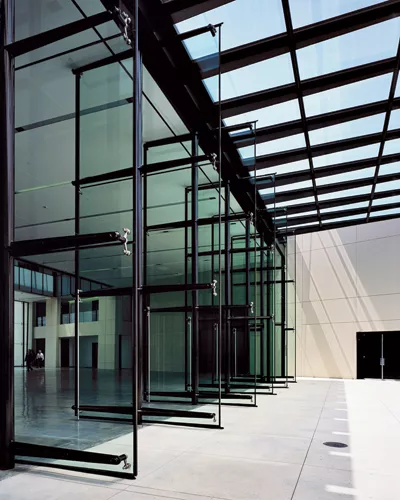 Pivoting glass doors connect the Design Center with the entry plaza.