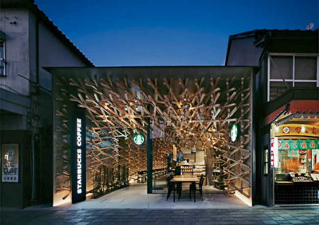 In Dazaifu, Japan, Kengo Kuma's team inserted a web of elongated wooden blocks into a retail shell on a busy road that leads to a major religious shrine.