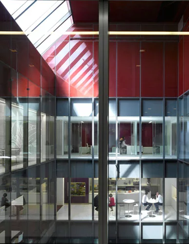 An atrium cuts down through the levels, bringing daylight to the innermost spaces. LSM lined the transparent volume with offices, a caf', and public areas to promote connectivity and interaction.