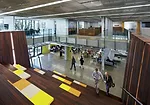 The design team transformed the precast-concrete former data center with a glazed courtyard; a shaded patio for outdoor lunches; and bleachers edged by stairs that provide a friendly spot for company 