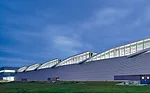 Balanced with an energy-efficient lighting system, a series of shed roofs and skylights were installed to infuse the factory with ample daylight&mdash;said to boost employee productivity&mdash;and als