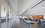 Amenities, like the sun-filled cafeteria, provide comfortable employee downtime and a place for management to share ideas with the production team.