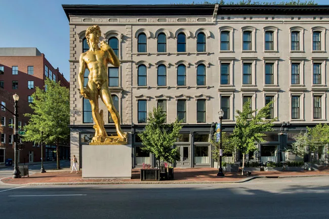 The colossal work, <em>David Inspired by Michelangelo</em> (2012) by Serkan 'zkaya, marks the location of 21c on Main Street.