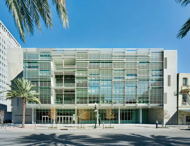 Playfully deployed louvers allow the main, southwest-facing facade to be 63 percent glass yet have the summer solar gain of a facade with only 20 percent glass.