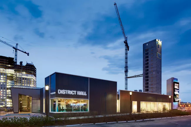 District Hall's two volumes include an 'abalone'-colored, angular shell containing a glass-enclosed restaurant.
