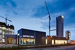 District Hall's two volumes include an 'abalone'-colored, angular shell containing a glass-enclosed restaurant.