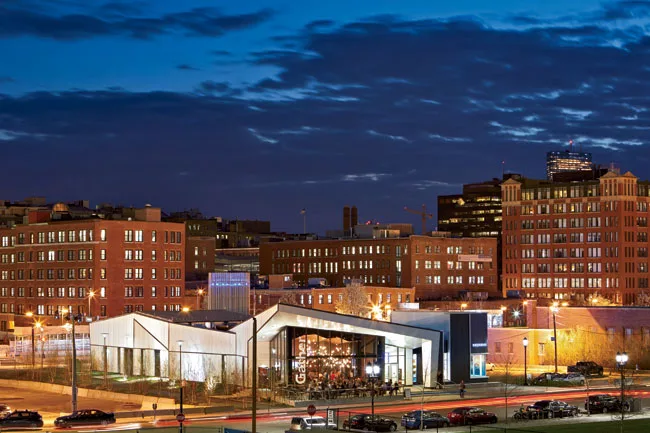 To the west, a lower-profile series of corrugated metal boxes that house work spaces and lounges.