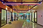 A programmable spine connects the center's eastern and western volumes. Users can write on the erasable walls, and the light fixtures can change colors for different events.
