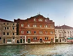 Built in the 1850s as a granary warehouse and converted into the city's only hostel 100 years later, the waterfront property on the Giudecca maintains its original masonry facade.