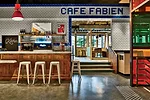 The caf' mimics the city's social scene.