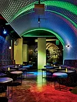 The design team reclaimed some of the building's underground parking garage to create a lower-level bar ' la Paris Metro.