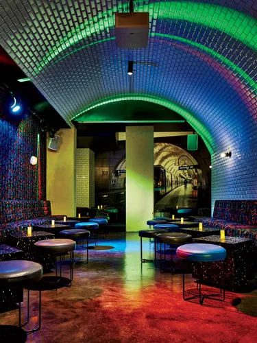 The design team reclaimed some of the building's underground parking garage to create a lower-level bar ' la Paris Metro.