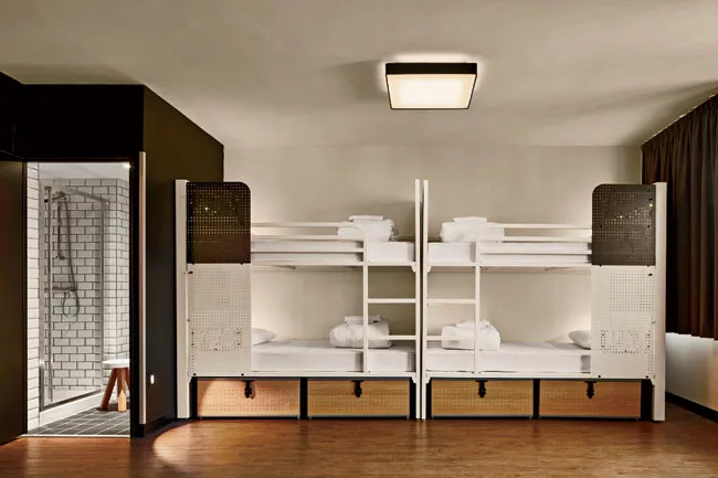 Shared rooms are simple and functional, with en-suite bathrooms, personal lights, and Wi-Fi.