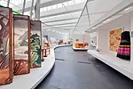 Hodgetts + Fung’s waferlike canopies shield the sun from the museum’s skylights. The 1930s folding screen was designed by Millard Sheets and the 1942 skirt and jacket ensemble by Louella B