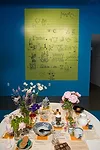 The letter on yellow-lined paper is a rebus puzzle, or pictogram, that Charles Eames sent his grandchildren while on a trip to Moscow. Ray’s Table, honoring Ray Eames, was arranged by Eames Offi