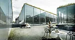 According to Bjarke Ingels Group, their 2012 museum proposal for a former WWII fortress in Denmark is “a light and easy antithesis of bunker architecture.” The rendering—replete with