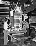 A photograph in the exhibition portrays apprentices at Taliesin, circa 1952, working on the model of the H.C. Price Company tower in Bartlesville, Oklahoma, 1952–56.