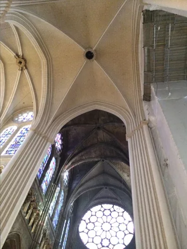 The newly cleaned and repainted columns and vaults contrasts sharply with the former ones in transept. The jewel-like, stained-glass, southern rose window in the background will lose the drama of emer