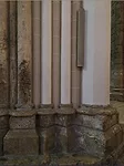 The juncture between the stone floor and base of the columns and the newly painted columns is shocking, and the latter make the untouched areas look dirty.