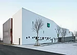 In the kindergarten, two parallel structures play in opposition to each other. A formidable concrete block encloses the circulation ramps for the school, while a punctured block with perforated alumin