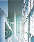 The site of this office building was initially designated to be open green space. So instead of designing the building as an intrusion on its surrounding park, Atelier Deshaus wanted the park to intru