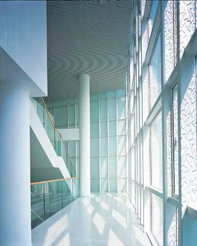 The site of this office building was initially designated to be open green space. So instead of designing the building as an intrusion on its surrounding park, Atelier Deshaus wanted the park to intru