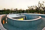 Like a Richard Serra sculpture, the building has a simple exterior hiding a complex interior and a form that unfolds as the viewer moves through it. To extend the visitor's experience at this small ga