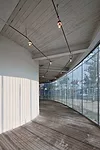 Like a Richard Serra sculpture, the building has a simple exterior hiding a complex interior and a form that unfolds as the viewer moves through it. To extend the visitor's experience at this small ga