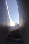 Like a Richard Serra sculpture, the building has a simple exterior hiding a complex interior and a form that unfolds as the viewer moves through it. To extend the visitor's experience at this small ga