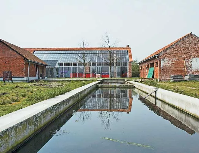 Doepel Strijkers converted former farm buildings in Meer, Belgium, into a compound for a furniture designer and artist. The new complex includes a residence, showroom, theater, guest lodging, and a ba