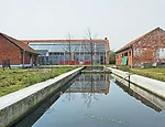 Doepel Strijkers converted former farm buildings in Meer, Belgium, into a compound for a furniture designer and artist. The new complex includes a residence, showroom, theater, guest lodging, and a ba