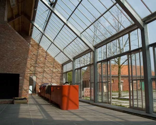 Doepel Strijkers converted former farm buildings in Meer, Belgium, into a compound for a furniture designer and artist. The new complex includes a residence, showroom, theater, guest lodging, and a ba