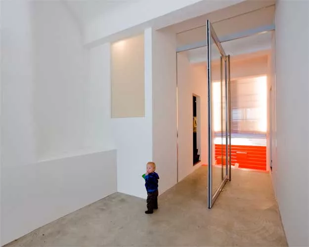 Doepel Strijkers transformed a former ambulance garage into a single-family home. By replacing the back wall with sliding-glass doors, they brought in both daylight and a view of the secluded park, he