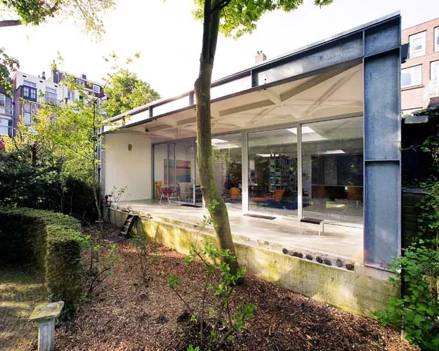 Doepel Strijkers transformed a former ambulance garage into a single-family home. By replacing the back wall with sliding-glass doors, they brought in both daylight and a view of the secluded park, he