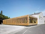 An addition to an existing warehouse in Glasgow, this project provides a showroom and offices, and serves as a kind of billboard advertising the sawmills. The architects used timber components machine