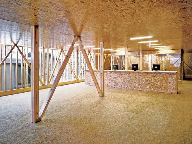 An addition to an existing warehouse in Glasgow, this project provides a showroom and offices, and serves as a kind of billboard advertising the sawmills. The architects used timber components machine