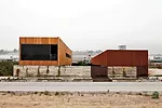For a 9,622-square-foot cooking school in Tijuana, Gracia designed a pair of structures facing each other on a 10,760-square-foot site. A wide interior pedestrian street separates the two buildings an