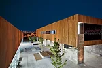 For a 9,622-square-foot cooking school in Tijuana, Gracia designed a pair of structures facing each other on a 10,760-square-foot site. A wide interior pedestrian street separates the two buildings an
