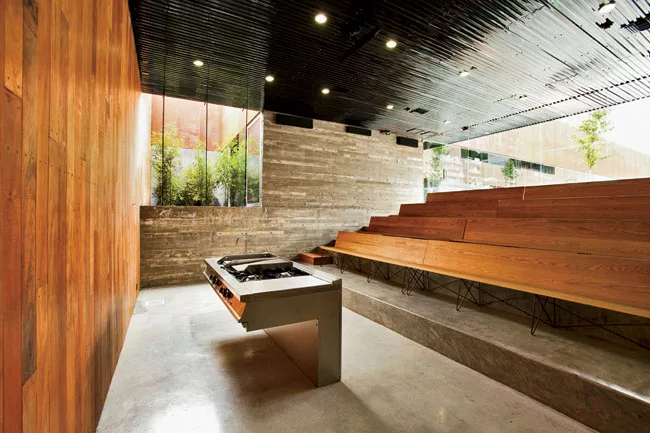 For a 9,622-square-foot cooking school in Tijuana, Gracia designed a pair of structures facing each other on a 10,760-square-foot site. A wide interior pedestrian street separates the two buildings an