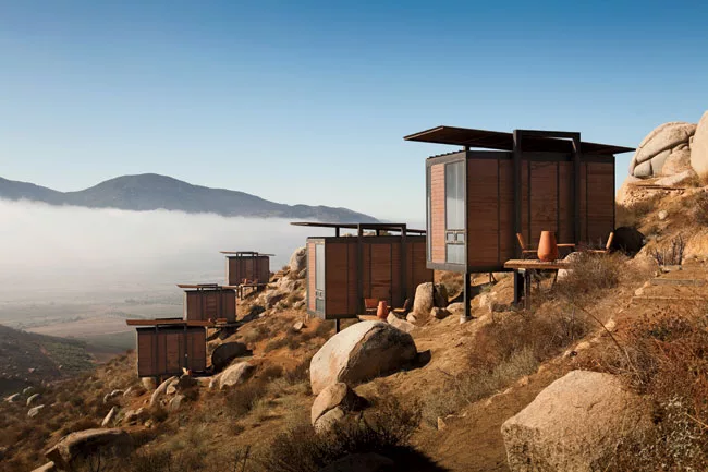 This hotel, operated by Grupo Habita, the boutique-hotel company based in Mexico City, is composed of 20 Minimalist guest structures perched on a hillside above a vineyard. Gracia designed the rusty-b