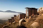 This hotel, operated by Grupo Habita, the boutique-hotel company based in Mexico City, is composed of 20 Minimalist guest structures perched on a hillside above a vineyard. Gracia designed the rusty-b