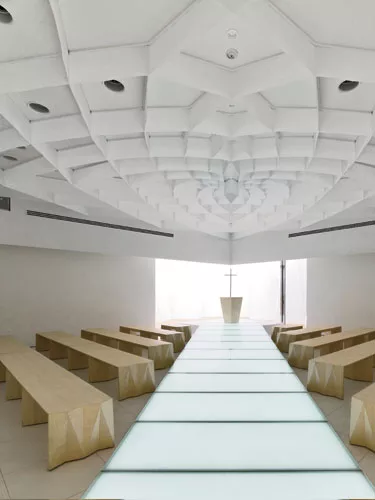 Designed specifically for weddings, Forest Chapel appears as an abstract white box amid a garden site in Gunma prefecture. Leaving its plain wrapping outside, the modest building comes into full bloo