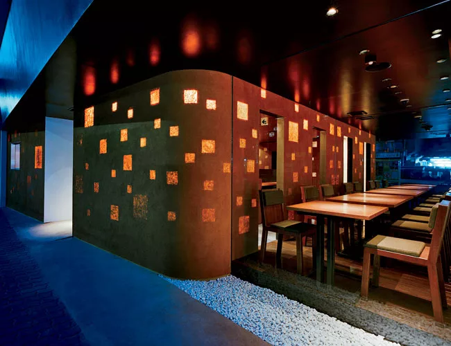Ogawa's first project after opening his firm, Kimukatsu is a restaurant in central Tokyo. Hired to design the interior and facade, Ogawa called upon a traditional mason to cover the shopfront with a t