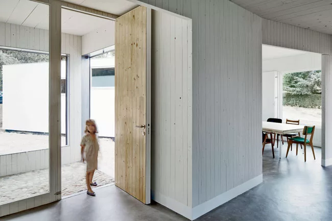 This lightweight structure in northern Madrid is built of computer-cut, cross-laminated wood walls, floors, and roofs, and floats on micropiles so as not to harm tree roots. Eleven pavilions (living, 